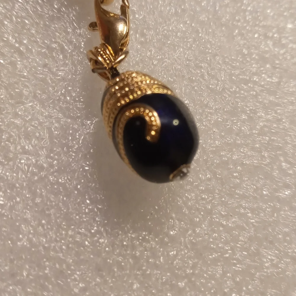 Faberge egg charm bracelet on a gold tone rolo chain. - Picture 7 of 16